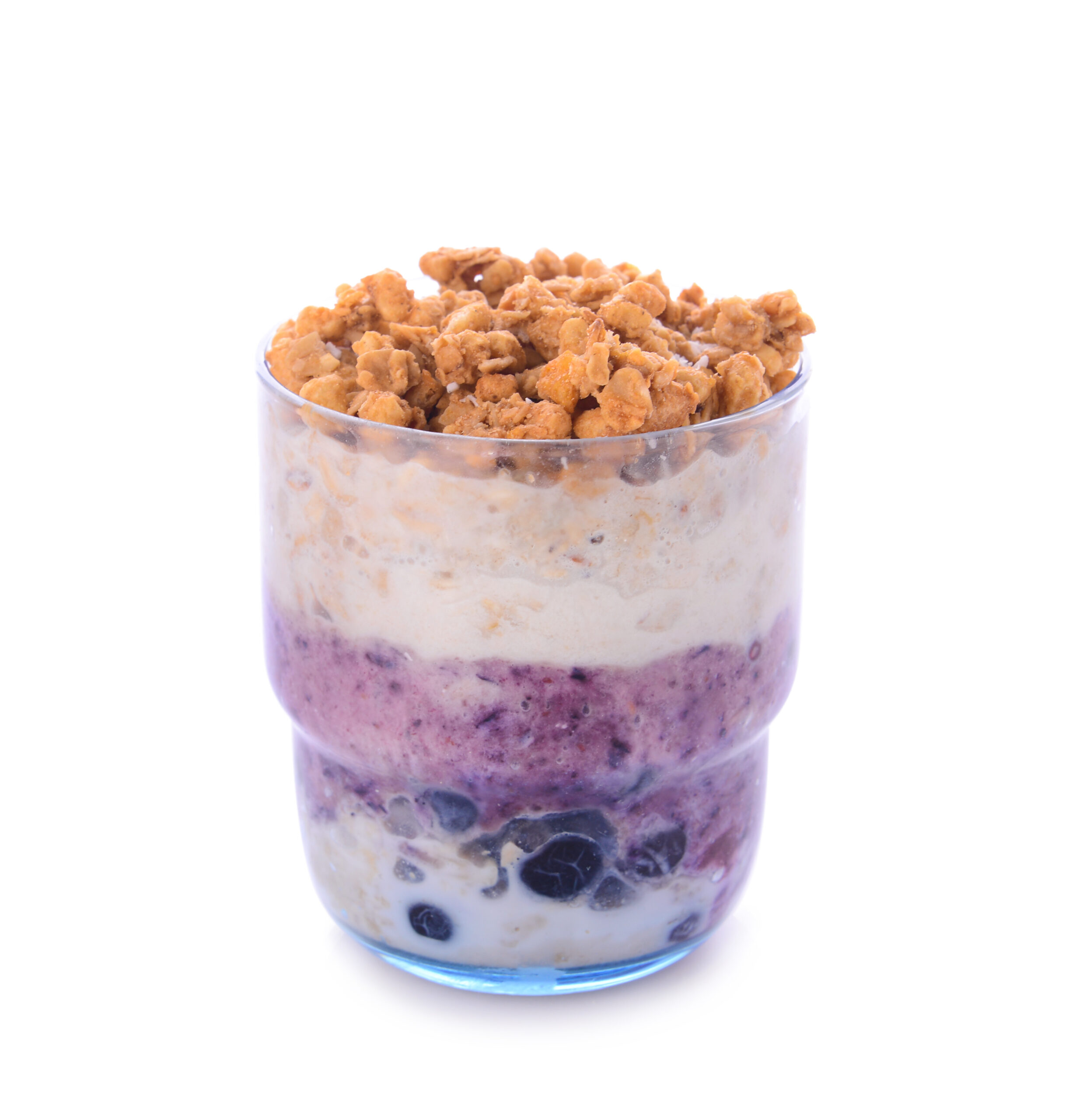 Glass with tasty granola and yogurt on white background