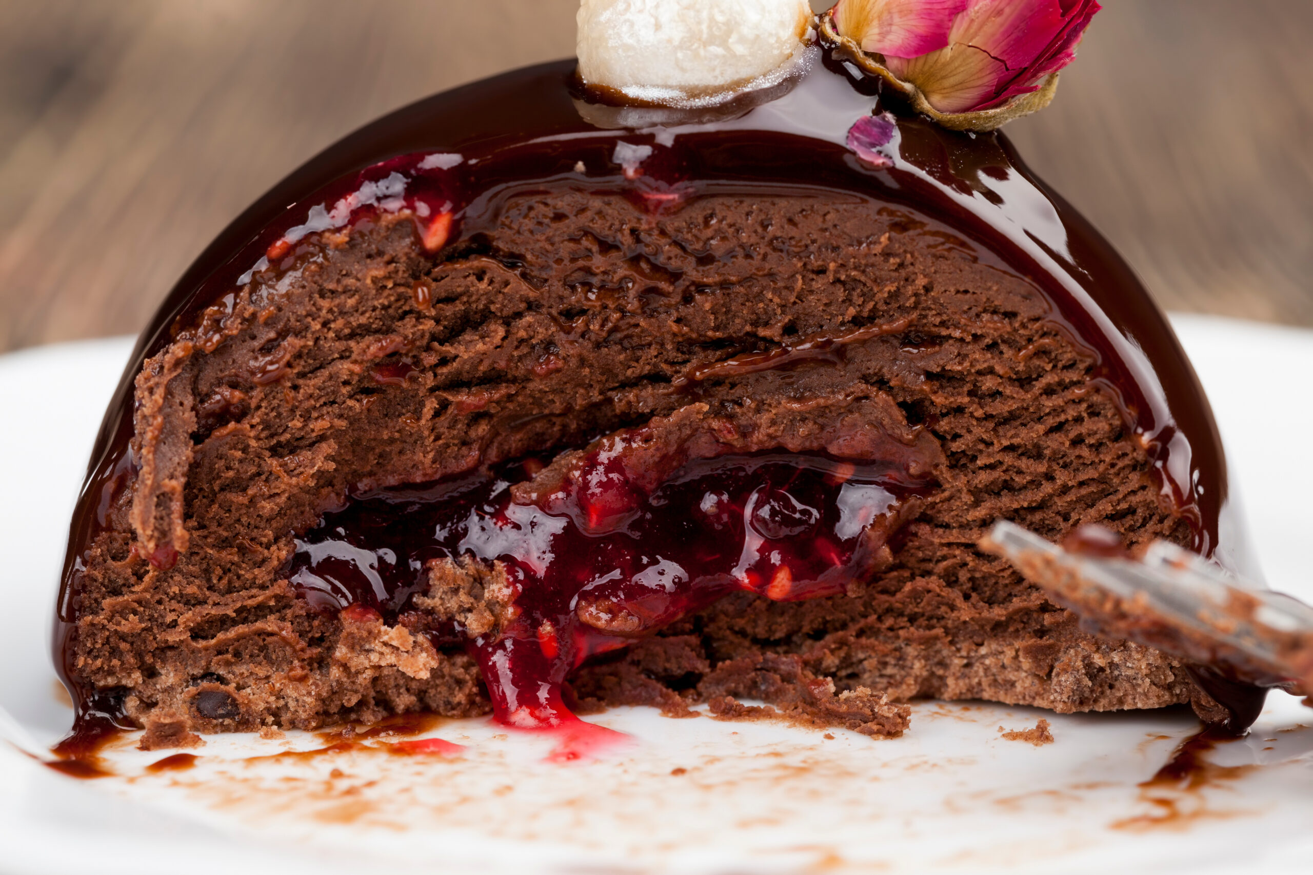 Chocolate dessert with glossy raspberry fruit filling showing structure and stability. raspberry jam dessert and butter and chocolate cake, chocolate cake with raspberry filling