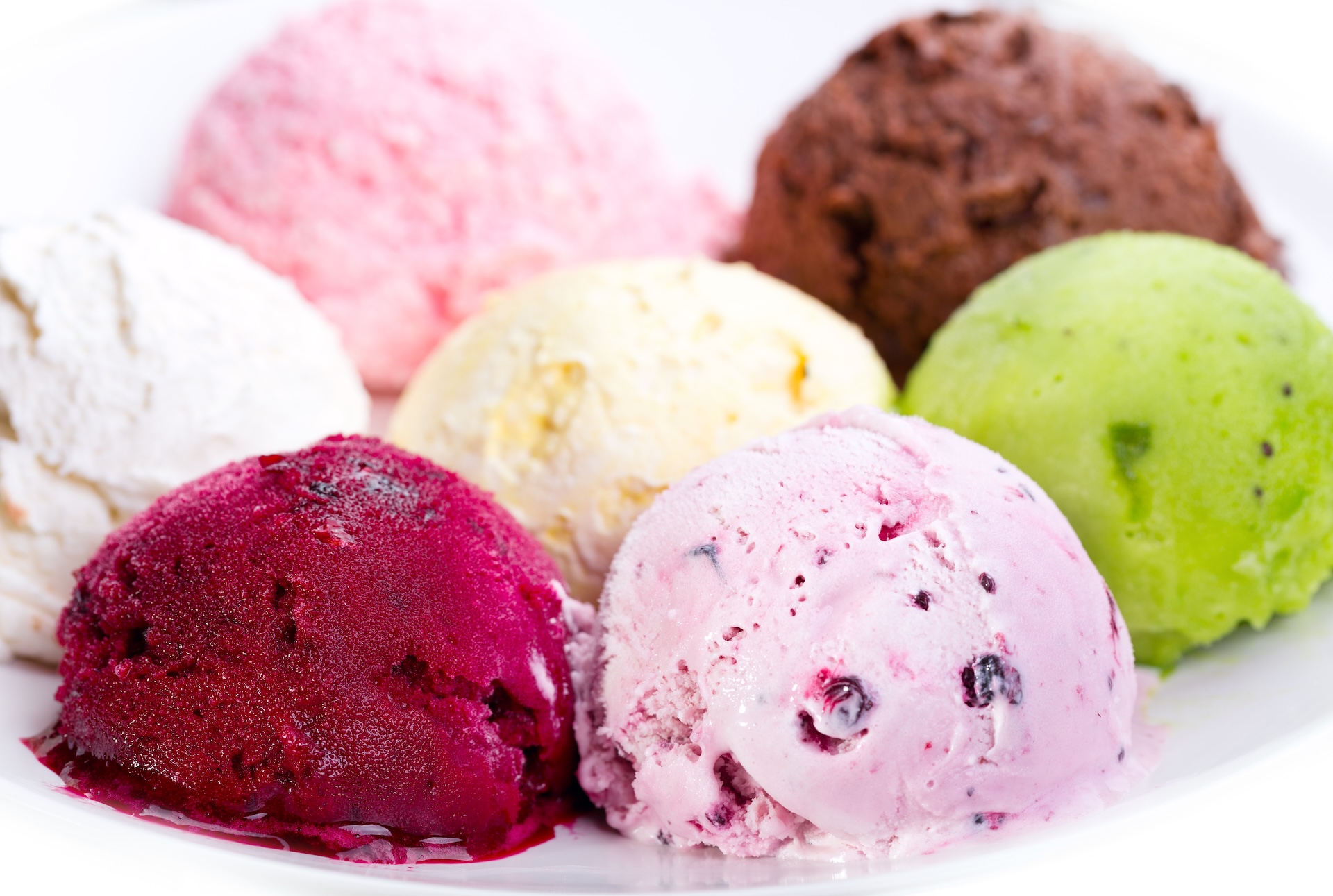 Assorted scoops of global-inspired ice cream flavors used in dairy formulation projects.