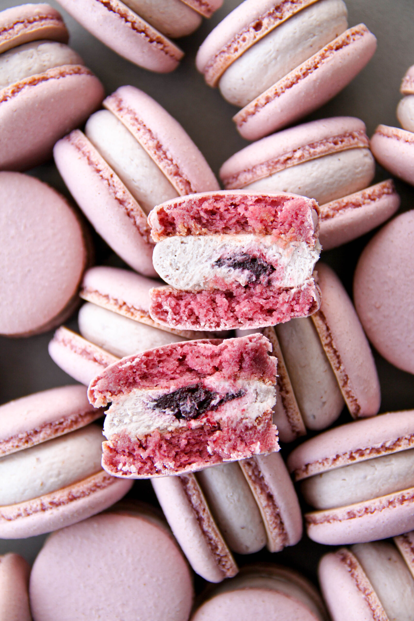 Pink macarons with fruit filling, representing shelf-stable confection systems.