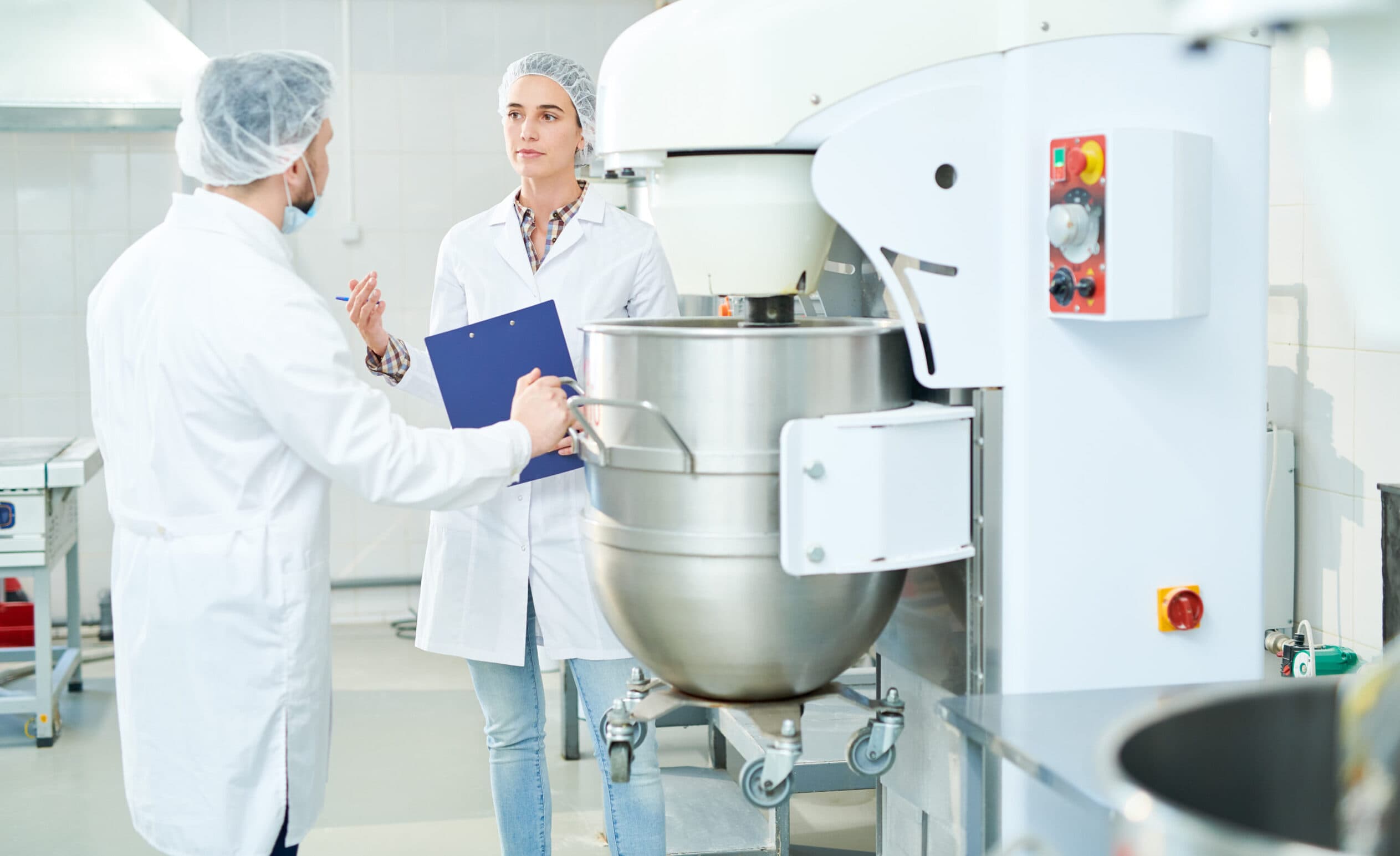 Food manufacturing team reviewing equipment as part of a culture of innovation