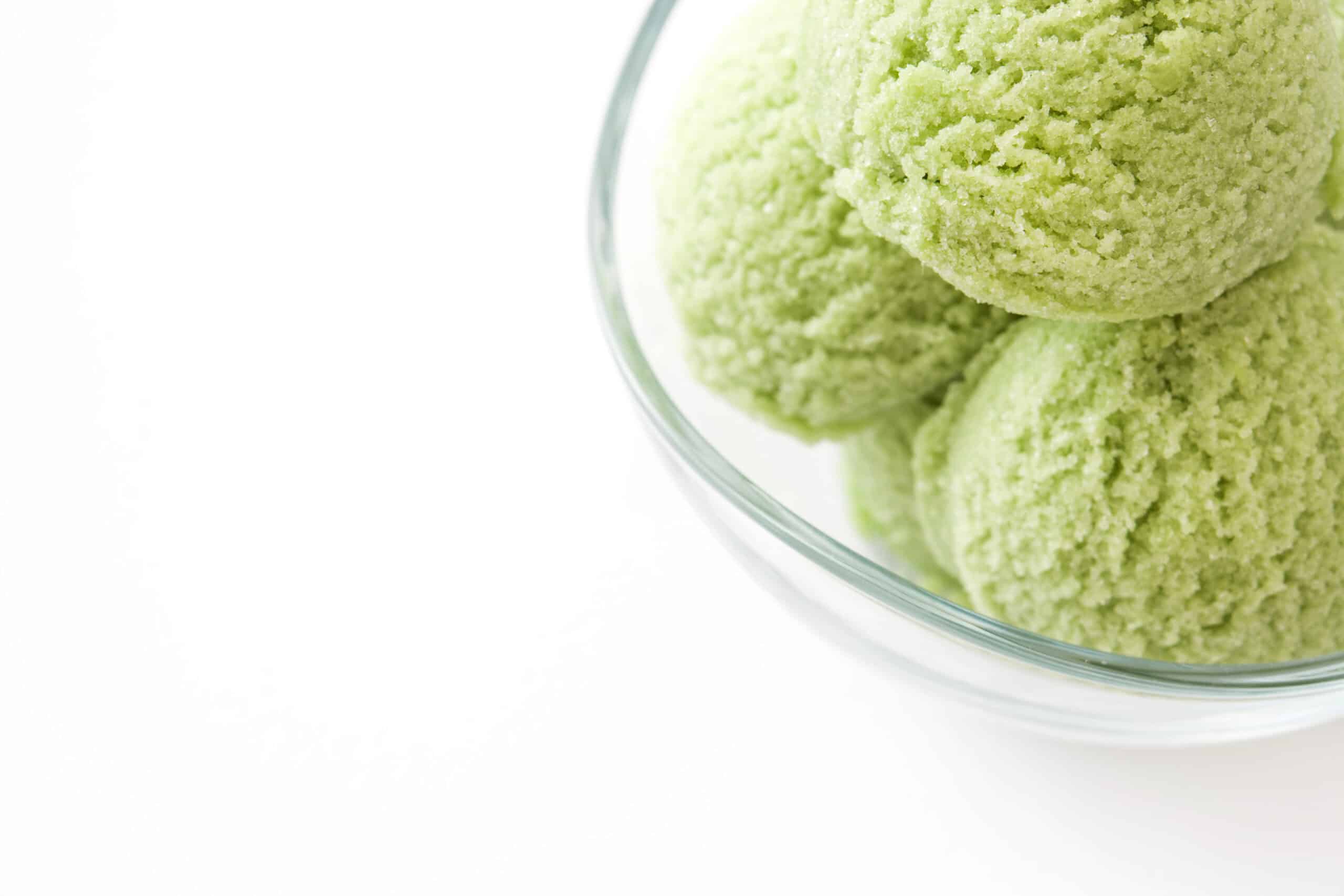 Vibrant green matcha scoops in a glass bowl, representing botanical and international flavor innovation in ice cream.