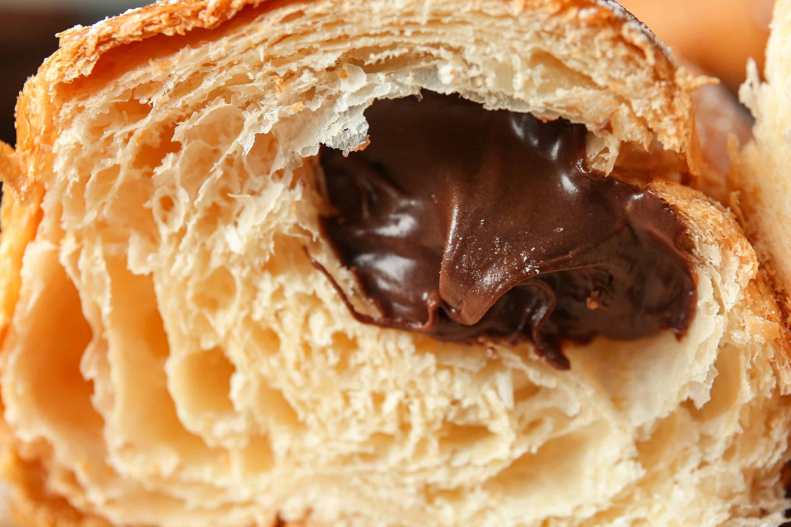 Flaky laminated chocolate croissant displaying 2026 bakery trends in hybrid formats and texture innovation