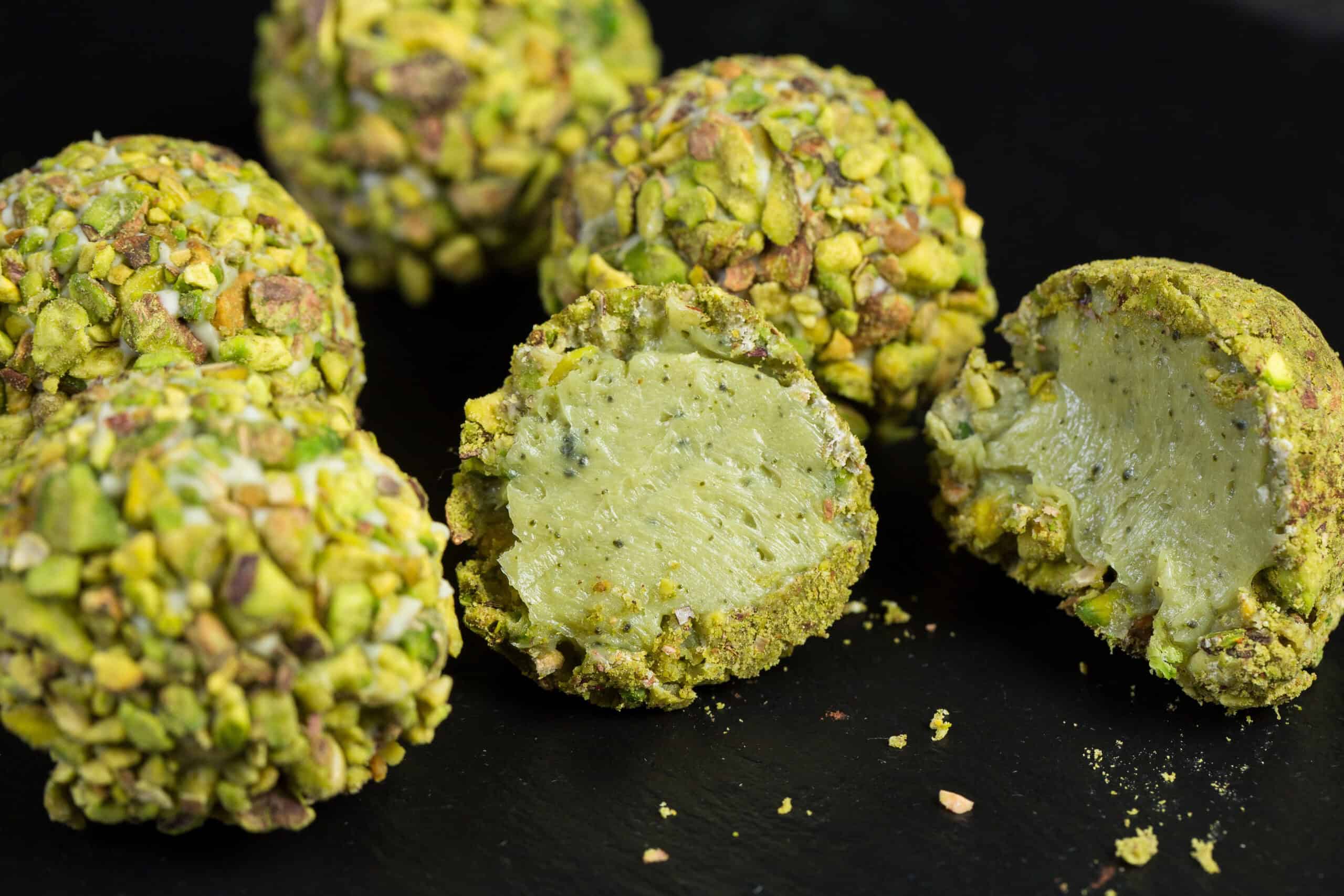 Pistachio-coated macarons with creamy filling showing vibrant natural green color and innovative flavors in bakery products