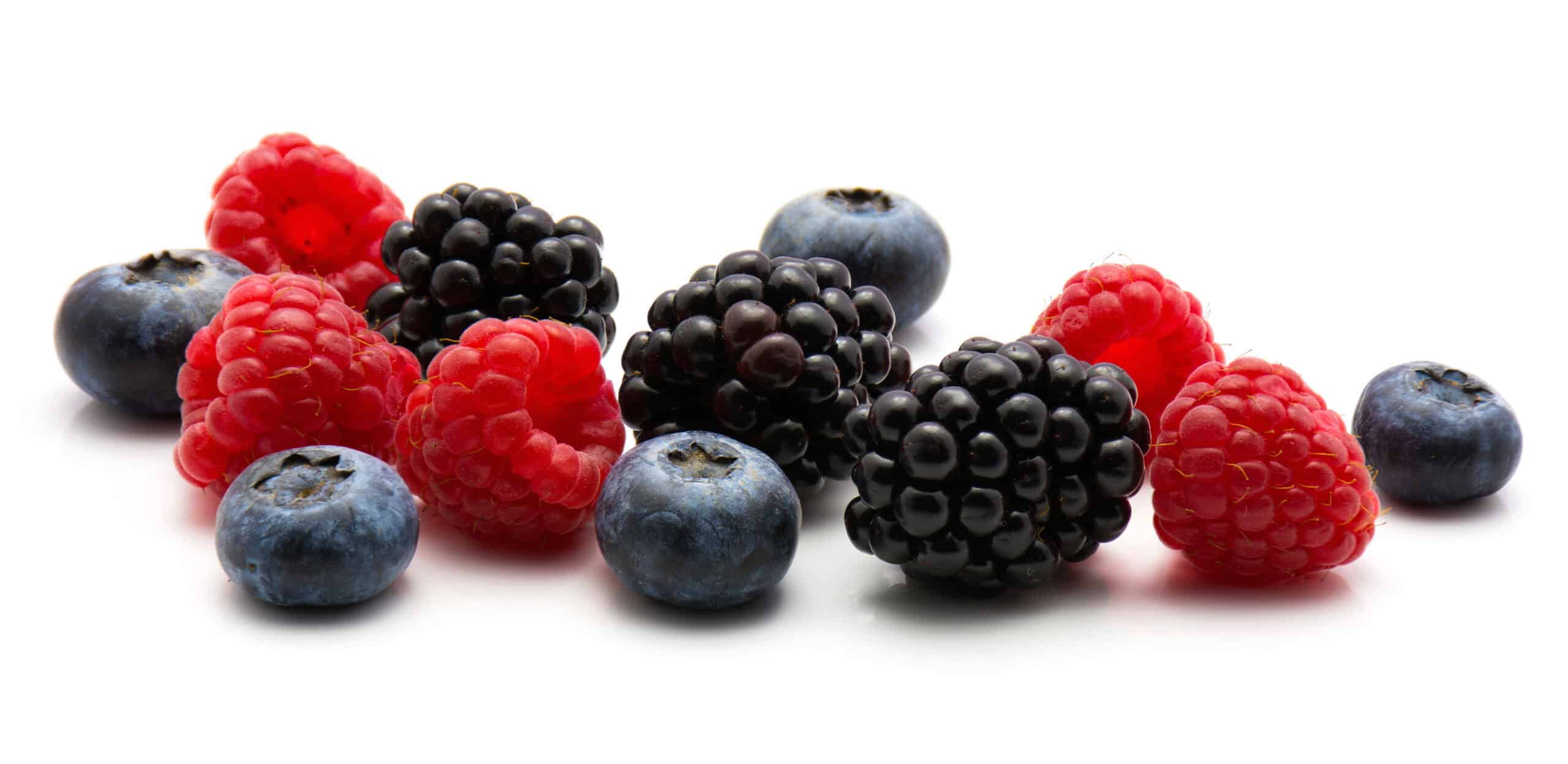 Fresh blueberries, raspberries, and blackberries grouped together on a white background representing classic berry varieties in bakery