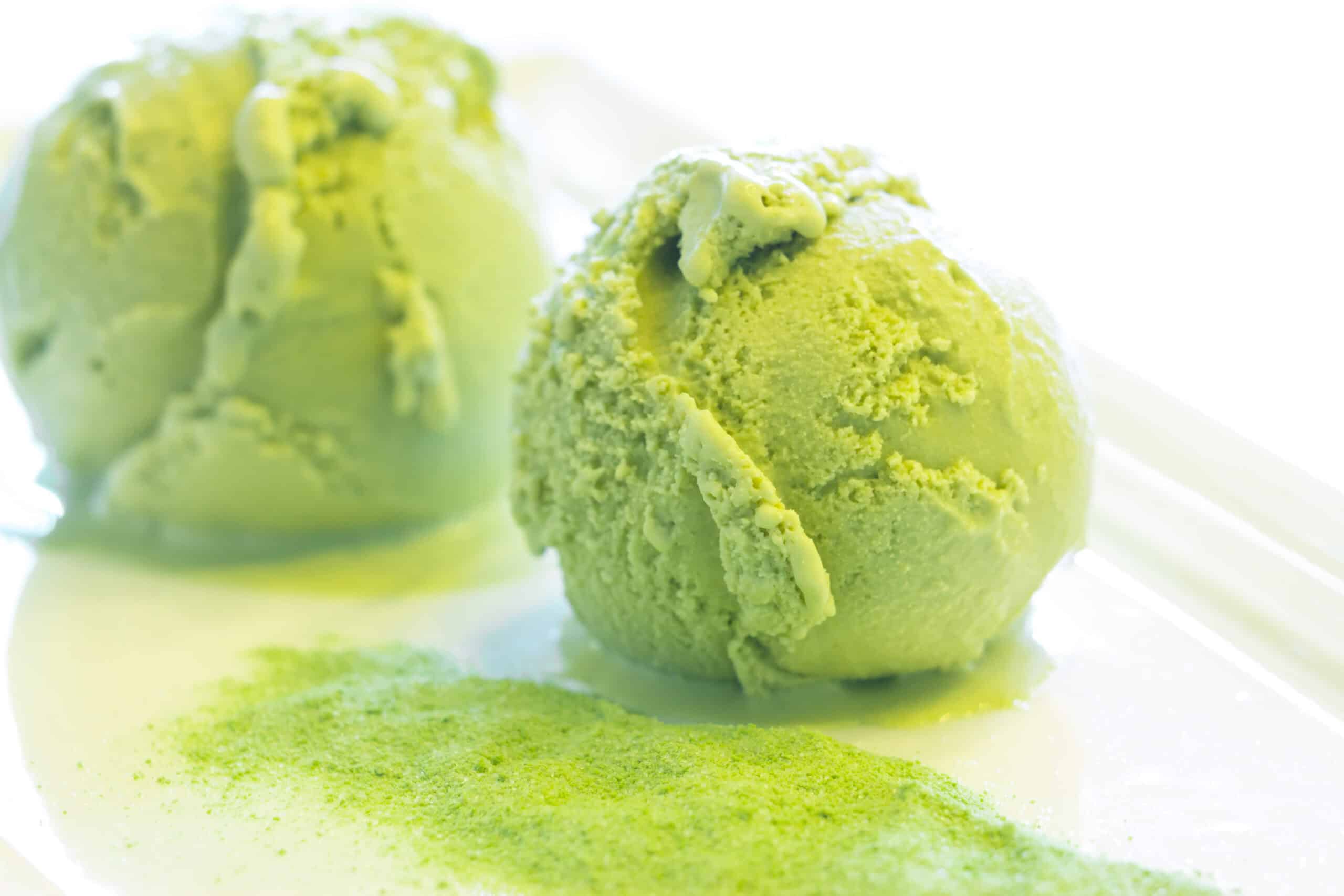 Vibrant green matcha ice cream scoops dusted with matcha powder, superfood ingredient