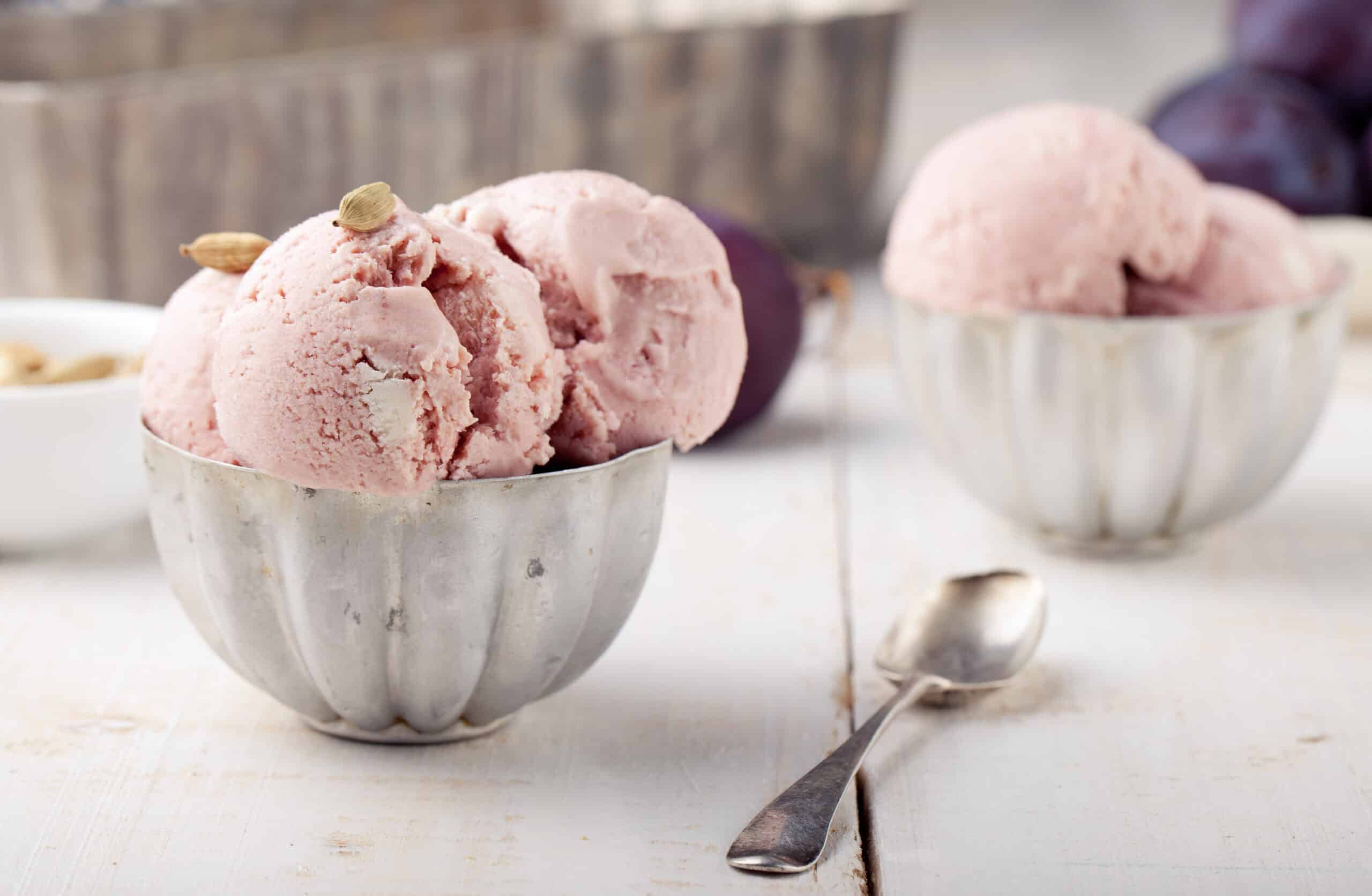 Soft plum ice cream topped with aromatic cardamom seeds