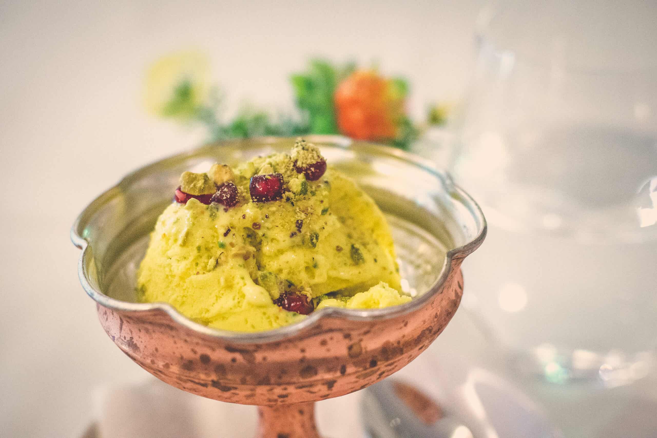 Golden saffron ice cream with pistachio nuts and saffron threads