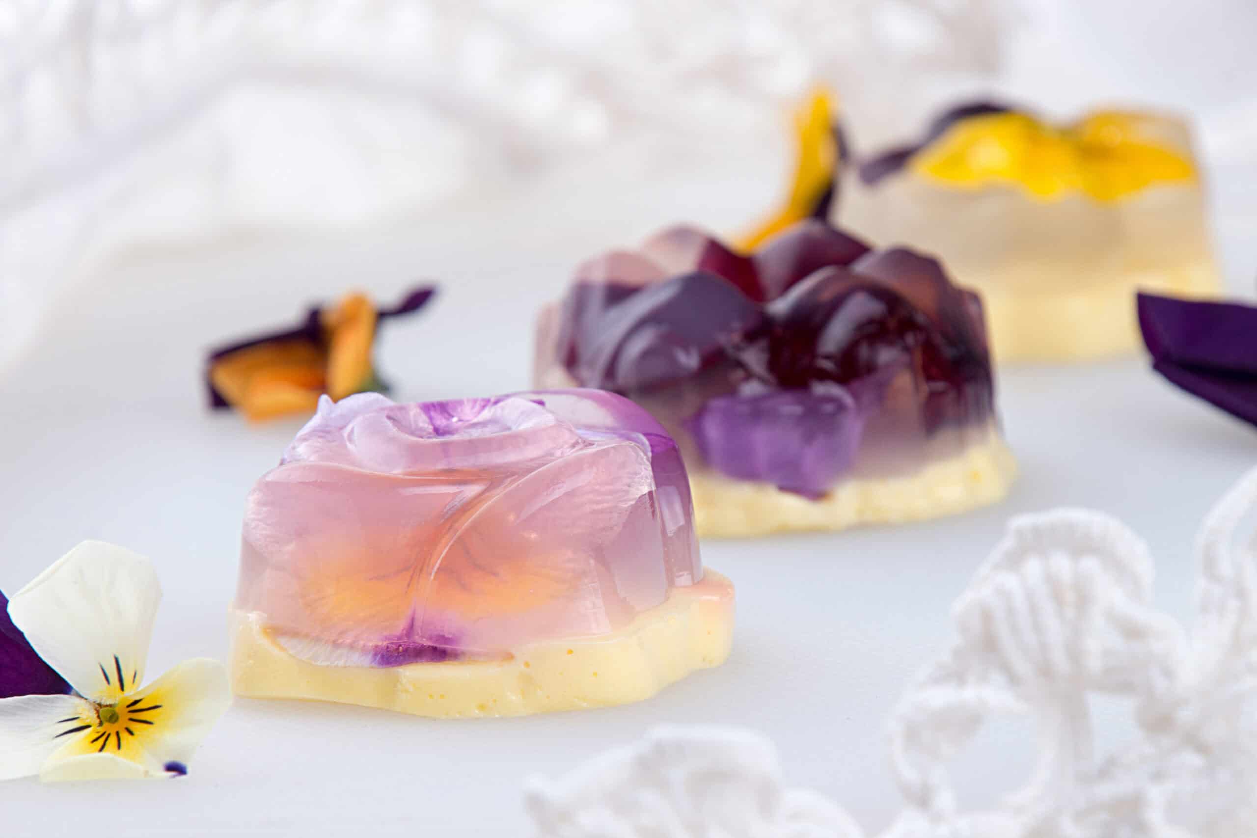 A slice of lavender-flavored cake decorated with edible flowers, highlighting botanical flavors in bakery desserts.